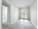 Bright entryway features wood-look floors and decorative glass double doors at 278 Acorn Dr, Longwood, FL 32750
