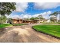 An expansive front view of a beautiful single story home with green lawns at 2814 Conway Gardens Rd, Orlando, FL 32806