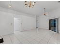 Spacious living area featuring tile floors, ceiling fan, and sliding glass doors to the lanai at 311 Lakebreeze Cir, Lake Mary, FL 32746