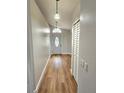 Bright hallway with wood-look flooring and view of the front door at 3146 Byington Terrace Ter, Deltona, FL 32738