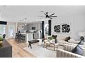 Bright and airy living space with a modern ceiling fan, stylish decor, and seamless access to the kitchen at 3363 Vine Leaf St, Apopka, FL 32712