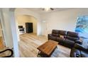 Cozy living room featuring wood floors, an archway, and a leather sofa set at 412 Bay Nw St, Fort Meade, FL 33841