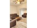 Inviting living room featuring wood-look floors and comfortable leather seating at 412 Bay Nw St, Fort Meade, FL 33841