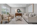 Bright living room featuring neutral tones, stylish furniture, and ample natural light streaming through the large window at 4161 Leafy Glade Pl, Casselberry, FL 32707