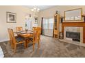 Cozy dining room with fireplace features a wooden table and views of the kitchen at 426 Vista Loop, Davenport, FL 33897