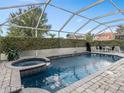 A covered outdoor pool and spa provide the perfect private, outdoor escape at 426 Vista Loop, Davenport, FL 33897