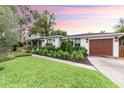 Stunning home with a well-manicured lawn and attractive brown garage door at 446 Piney Croft Ln, Maitland, FL 32751