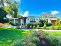 Charming home with a lush, green lawn and meticulously landscaped flower beds at 446 Piney Croft Ln, Maitland, FL 32751