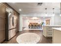 Open kitchen flows to the dining area with stainless steel appliances and luxury finishes at 446 Piney Croft Ln, Maitland, FL 32751