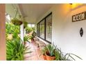 Inviting porch features potted plants and stone benches at 446 Piney Croft Ln, Maitland, FL 32751