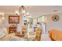 Inviting dining area with a glass table, chandelier, and adjacent bar with seating creates an elegant dining experience at 5300 S Atlantic Ave # 6-502, New Smyrna Beach, FL 32169
