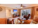Cozy living room with a comfortable seating area, television, and access to a balcony provides a relaxing retreat at 5300 S Atlantic Ave # 6-502, New Smyrna Beach, FL 32169