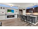 Modern kitchen featuring a fireplace, a wine fridge, and bar seating at 5464 Factors Walk Dr, Sanford, FL 32771