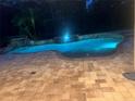 Inviting pool with illuminated waterfall, perfect for evening relaxation at 626 Green Rock Ct, Apopka, FL 32712
