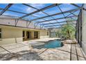 Screened-in lanai featuring a freeform pool with a waterfall feature at 626 Green Rock Ct, Apopka, FL 32712
