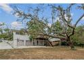 Expansive backyard featuring a two-car garage, upper deck and a covered patio under the deck perfect for outdoor entertaining at 6411 Merriewood Dr, Orlando, FL 32818