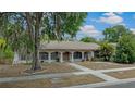 Charming single-story home featuring arched entryways and well-maintained front yard, creating a welcoming curb appeal at 6411 Merriewood Dr, Orlando, FL 32818