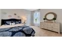 Comfortable bedroom featuring a plush bed, a decorative mirror, and soft carpeting, creating a cozy and inviting space at 7213 Nottingham Reel Ct, St Cloud, FL 34773