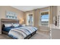 Inviting bedroom featuring a serene lake view, plush carpeting, and elegant decor, creating a peaceful retreat at 7213 Nottingham Reel Ct, St Cloud, FL 34773