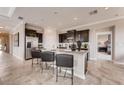 Modern kitchen with granite countertops, dark cabinetry, stainless steel appliances, and a breakfast bar at 7219 Nottingham Reel Ct, St Cloud, FL 34773