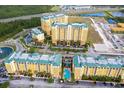 An aerial view showcasing the buildings, parking lots, and pool area of the condo community at 8101 Resort Village Dr # 31501, Orlando, FL 32821