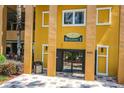 Building 3 exterior view featuring yellow walls, black doors, and visible signage at 8101 Resort Village Dr # 31501, Orlando, FL 32821