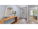Stylish entryway with wood-look flooring, a modern mirror, a decorated table, and a glass door at 1028 Morfontaine St, Daytona Beach, FL 32124