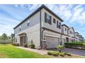 Attractive two-story townhome with a well-maintained lawn, and stone veneer accents at 11968 Sands Cv, Orlando, FL 32828