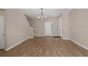 Inviting living area with light wood flooring and stairway access at 11968 Sands Cv, Orlando, FL 32828