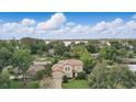 Stunning aerial shot of home with lush greenery and a glimpse of the lake in the background at 123 Tangelo Court, Maitland, FL 32751