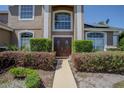 Inviting entryway with a double door and lush landscaping creating a warm and welcoming curb appeal at 12618 Greco Dr, Orlando, FL 32824