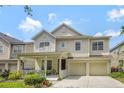 Charming two-story home featuring a welcoming front porch and a two-car garage at 14231 Sonco Ave, Windermere, FL 34786