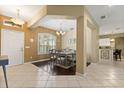 Elegant dining area with a stylish chandelier, a large window with shutters, and easy access to the kitchen at 1428 Lucky Pennie Way, Apopka, FL 32712