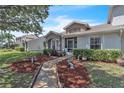 Beautiful townhome showcasing an inviting walkway, manicured landscape, and a sunny ambiance at 14650 Laguna Beach Cir, Orlando, FL 32824