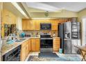 The kitchen features granite countertops, stainless steel appliances, and wood cabinetry at 14650 Laguna Beach Cir, Orlando, FL 32824