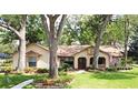 Charming single story home with mature landscaping and beautiful lawn at 1575 N Ridge Lake Cir, Longwood, FL 32750