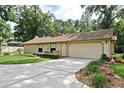 Spacious home with a well-manicured lawn and a large, two-car garage at 1575 N Ridge Lake Cir, Longwood, FL 32750
