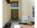 Inviting home entrance with double doors, stone pathway, and manicured landscaping at 1778 Waterside Oaks Dr, Orange City, FL 32763