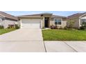 Attractive single-Gathering home with a two-car garage and landscaped front yard at 1975 Cacutta Way, Kissimmee, FL 34744