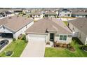 Aerial view of a single-Gathering home in a residential community with well-kept lawns at 1975 Cacutta Way, Kissimmee, FL 34744