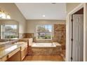 Luxurious primary bathroom features a soaking tub, walk-in shower, and dual sinks at 2019 Wintermere Pointe Dr, Winter Garden, FL 34787