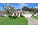 Charming one-story home featuring a lush green lawn, a two car garage, and tasteful landscaping at 2019 Wintermere Pointe Dr, Winter Garden, FL 34787