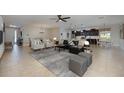Open-concept living room featuring modern decor, tile flooring, and lots of natural light at 217 Victoria Trails Blvd, Deland, FL 32724