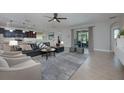 Inviting living room with tile floors, a plush sofa, and sliding glass doors to the patio at 217 Victoria Trails Blvd, Deland, FL 32724
