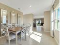 Bright dining room features tile floors, tall mirrors, with a large window for natural light at 2897 Elio Hammock Dr, St Cloud, FL 34773