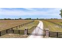 Gated property with long driveway and large open fields at 35651 Huff Rd, Eustis, FL 32736
