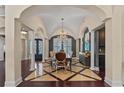 Formal dining room featuring elegant chandelier, designer tile, and adjacent butler's pantry at 5909 Oxford Moor Blvd, Windermere, FL 34786