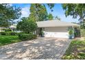 Well-maintained home featuring a spacious two-car garage and brick-paved driveway at 627 Darcey Dr, Winter Park, FL 32792