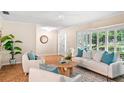 Inviting living room with comfortable seating, parquet floors, and bright natural light through shuttered windows at 627 Darcey Dr, Winter Park, FL 32792