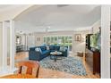 Bright and airy living room with hardwood floors, large windows, and stylish decor at 627 Darcey Dr, Winter Park, FL 32792